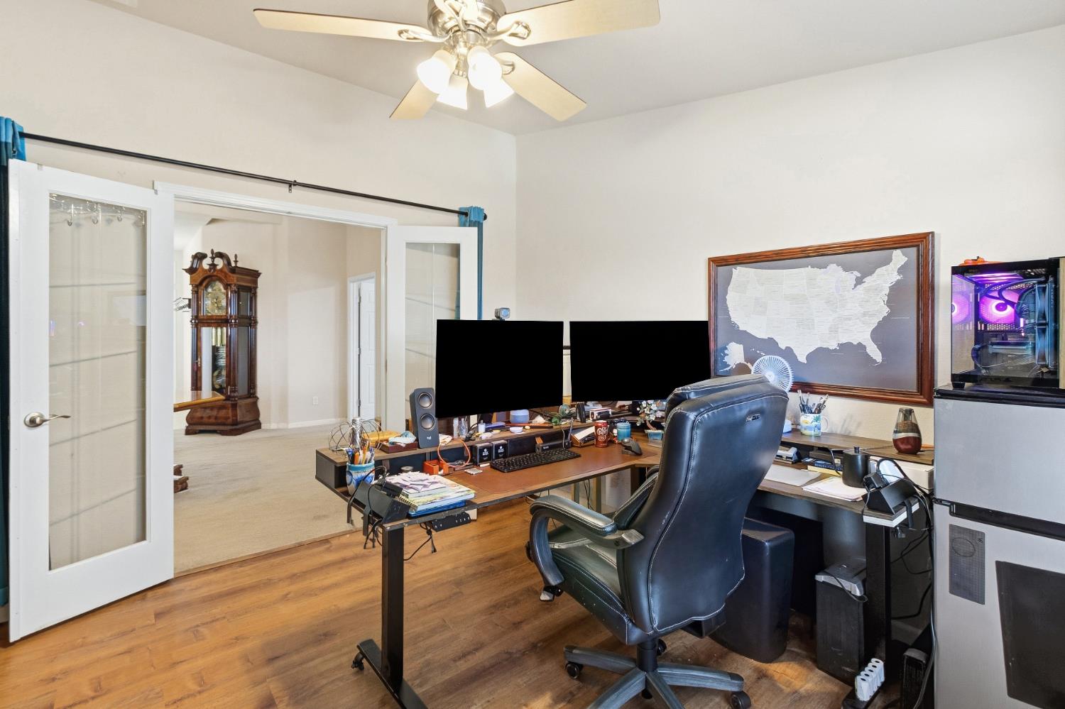12390 Hobday Road Wilton, CA 95693 - Photo 25 of 92 a view of a workspace with furniture and a flat screen tv