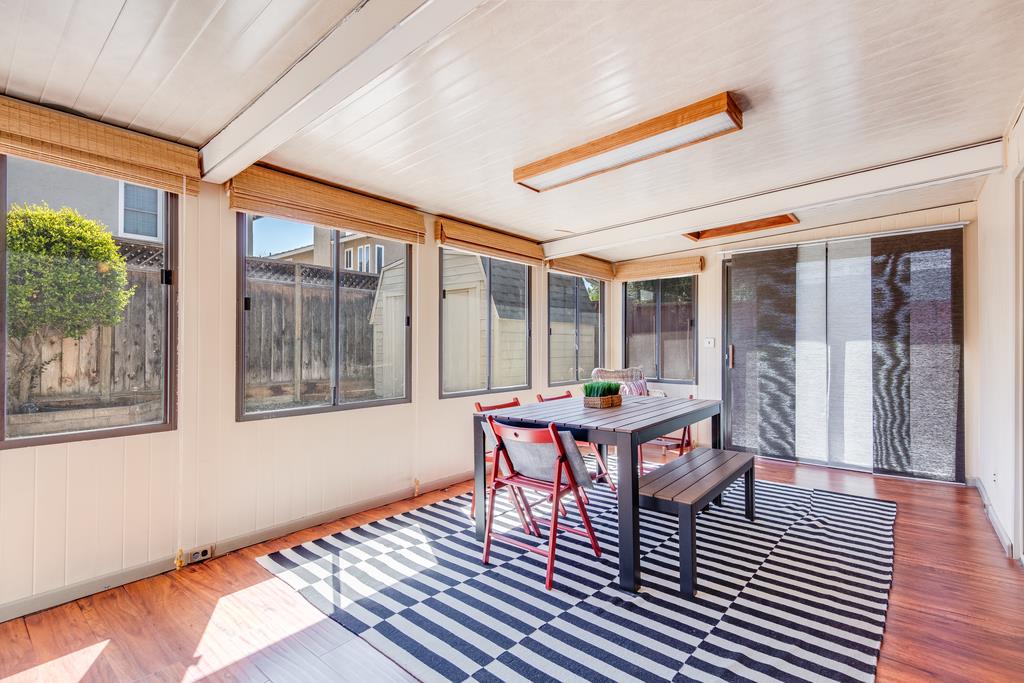 3129 Bilbo Drive San Jose, CA 95121 - Photo 14 of 34 a dining room with wooden floor a glass table and chairs