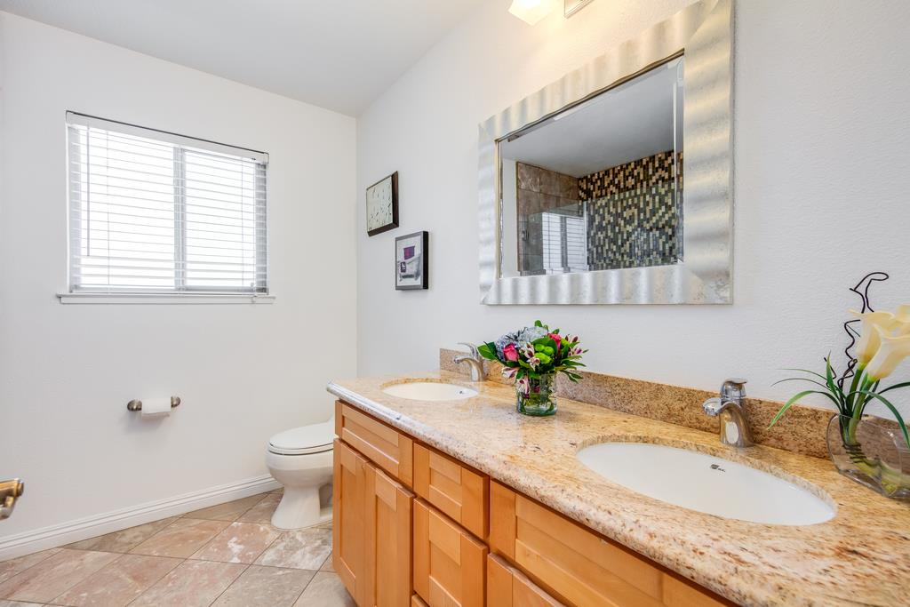 3129 Bilbo Drive San Jose, CA 95121 - Photo 19 of 34 a bathroom with a granite countertop sink mirror and a