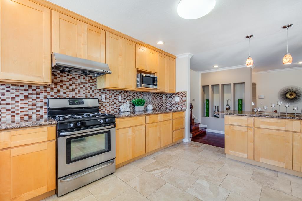 3129 Bilbo Drive San Jose, CA 95121 - Photo 10 of 34 a kitchen with stainless steel appliances granite countertop a stove a sink and a microwave