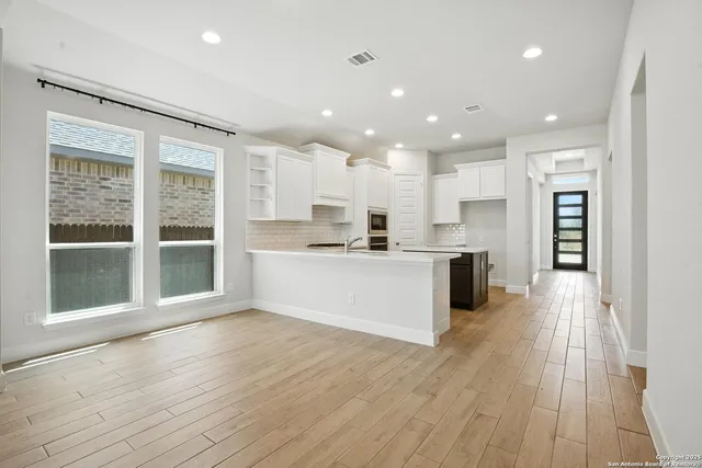 a view of kitchen with cabinets and wooden floor