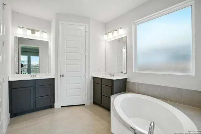 a bathroom with a bathtub and a sink