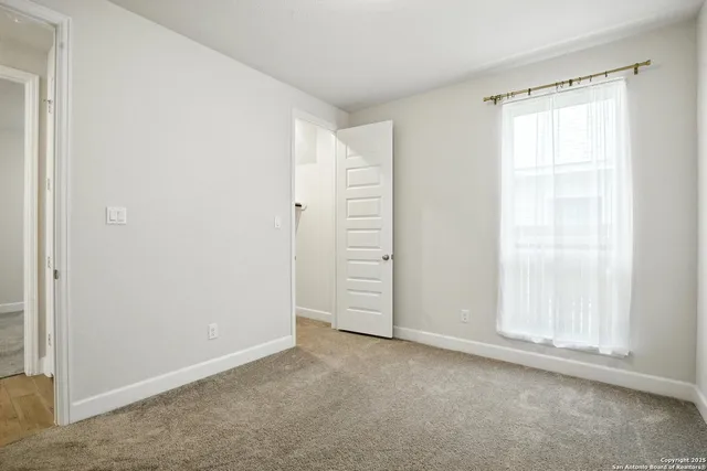 an empty room with window in closet