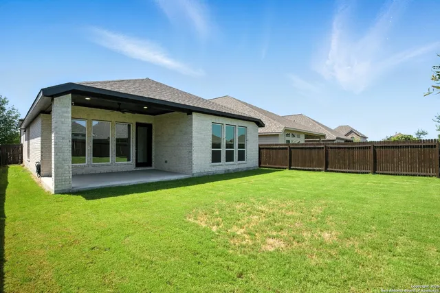 a view of a house with backyard and porch