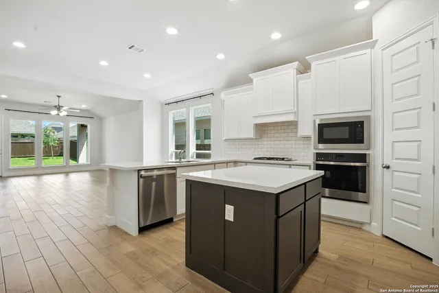 a kitchen with a stove and a microwave
