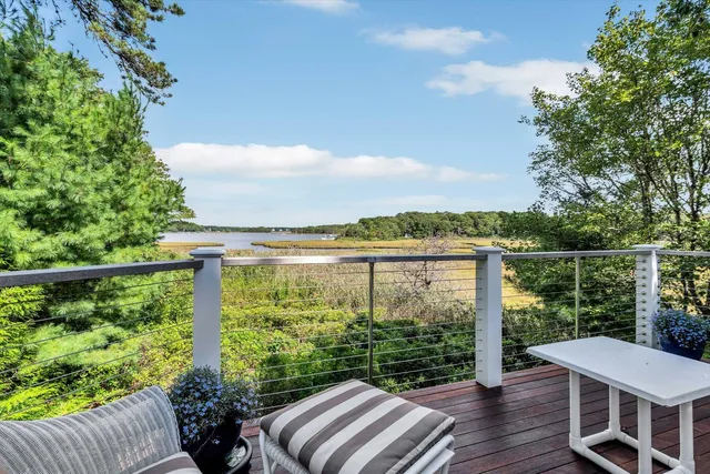 a living room with furniture and large windows