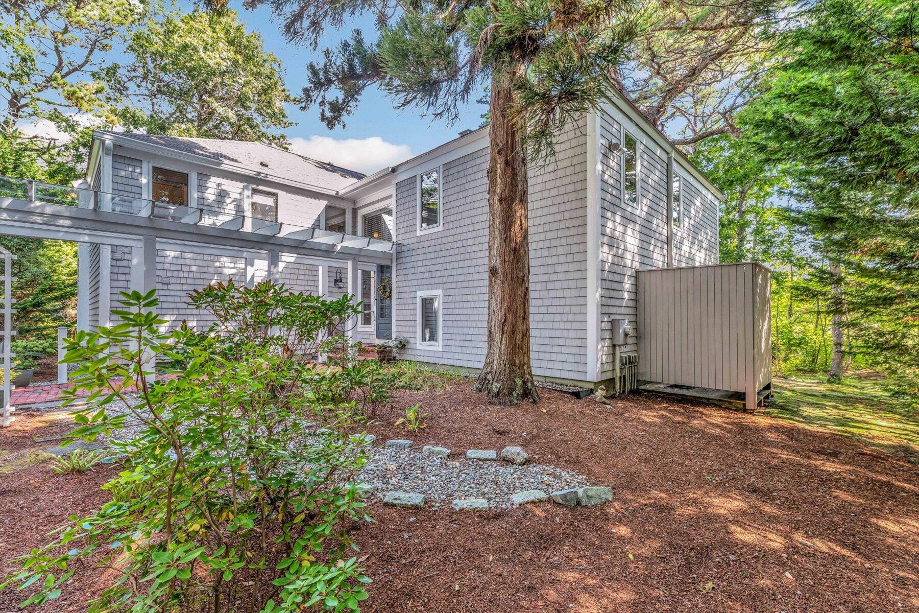 5 Tide Run Mashpee, MA 02649 - Photo 16 of 64 a view of a house with a yard and potted plants