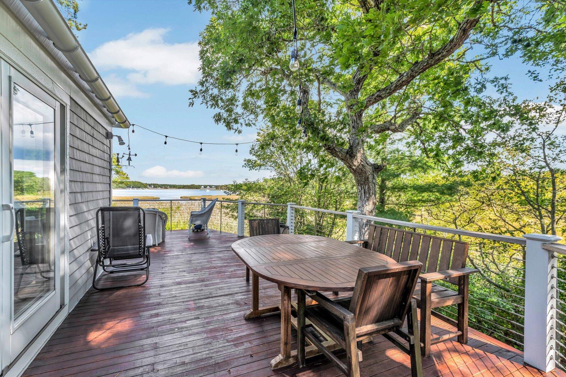 5 Tide Run Mashpee, MA 02649 - Photo 17 of 64 a view of a patio with table and chairs and wooden floor