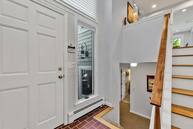 a dining room with furniture a rug and a floor to ceiling window