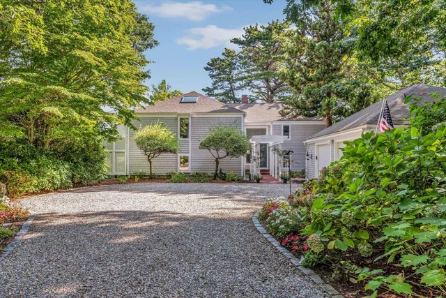 a front view of a house with a yard and a garage
