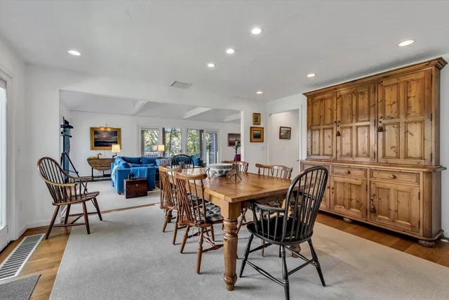 a dining room with furniture and wooden floor