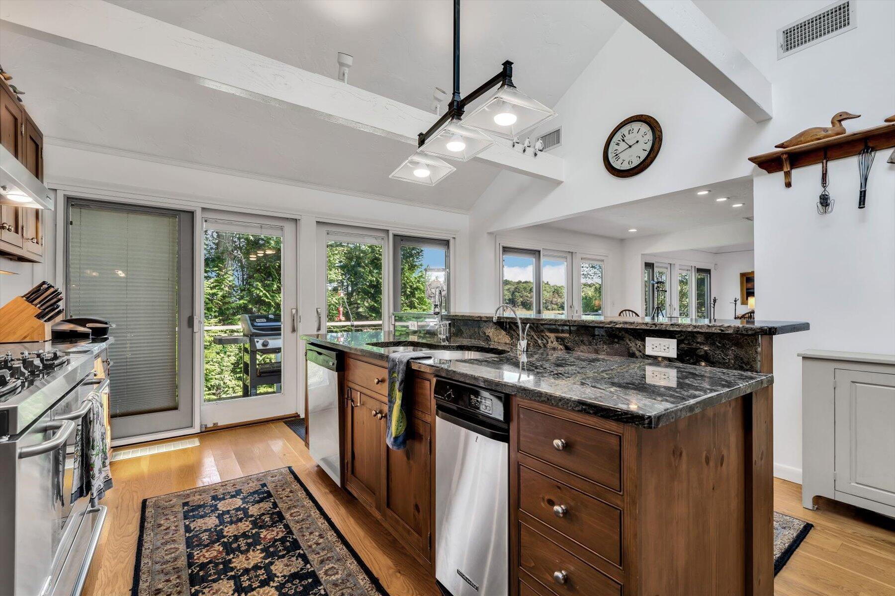 5 Tide Run Mashpee, MA 02649 - Photo 31 of 64 a kitchen with a stove and a clock on the wall
