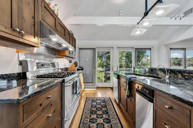 a bedroom with a bed and a dresser next to a window