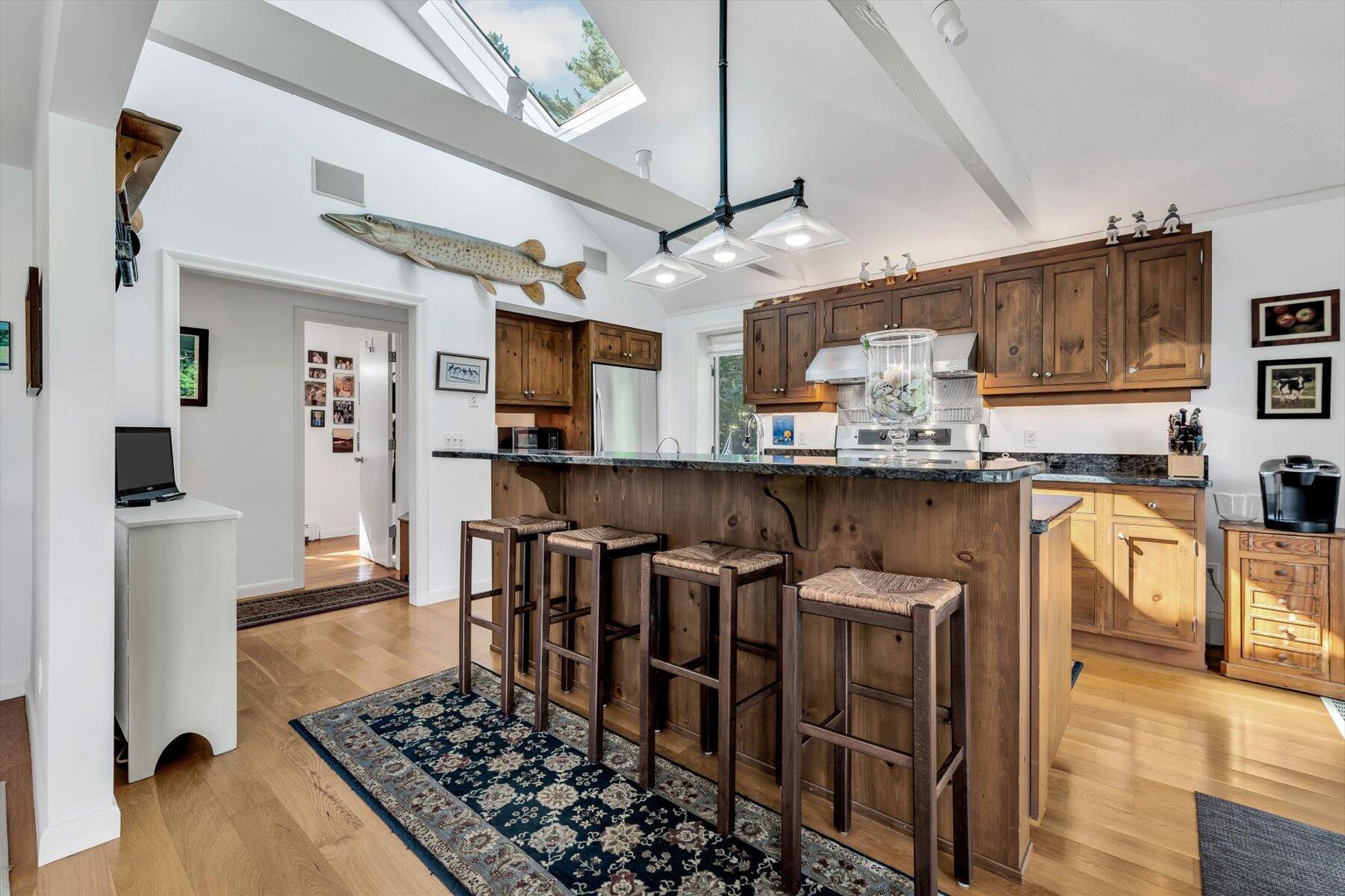 5 Tide Run Mashpee, MA 02649 - Photo 34 of 64 a kitchen with stainless steel appliances granite countertop a sink cabinets and wooden floor