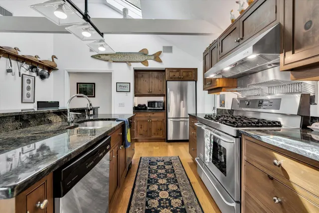 a bathroom with a double vanity sink toilet and shower
