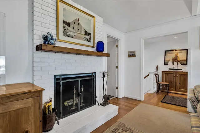 a living room with furniture a lamp a rug and a large window