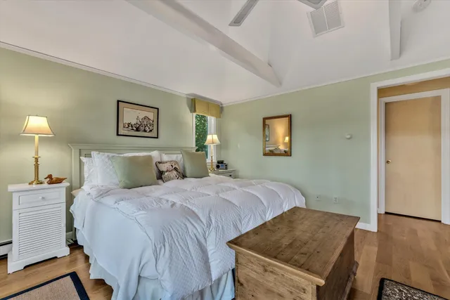 a bed sitting in a bedroom next to a window