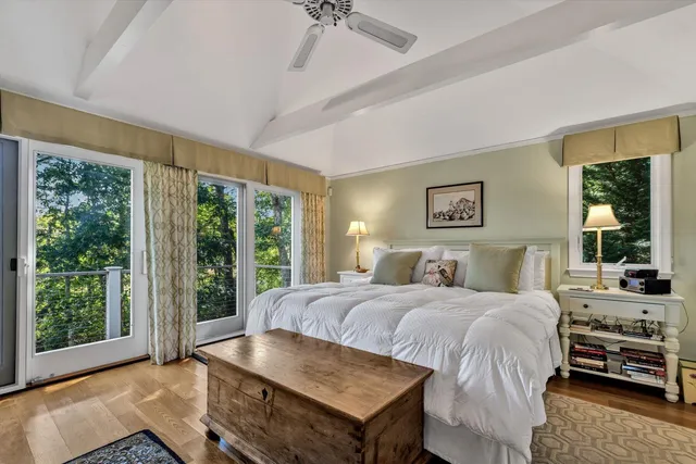 a bedroom with a bed and a large window