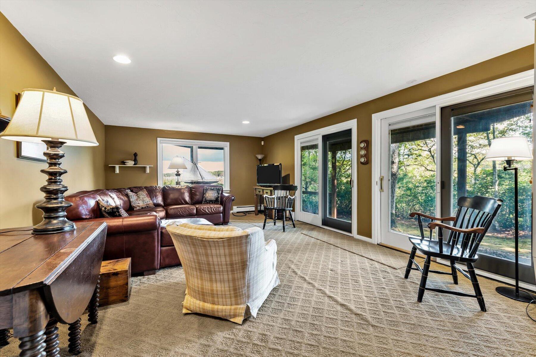 5 Tide Run Mashpee, MA 02649 - Photo 47 of 64 a living room with furniture a lamp a rug and a large window
