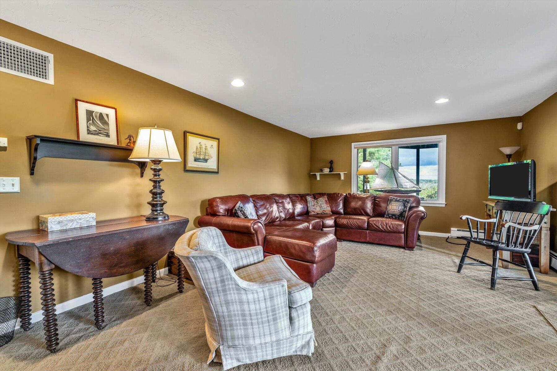 5 Tide Run Mashpee, MA 02649 - Photo 48 of 64 a living room with furniture a flat screen tv and a window