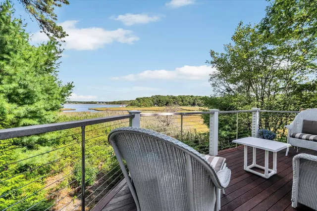 an aerial view of a house with outdoor space and lake view