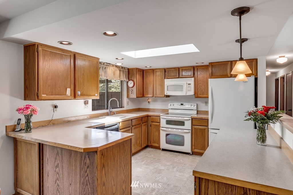 4903 169th Street Southeast Bothell, WA 98012 - Photo 13 of 32 a kitchen with a sink stove and refrigerator