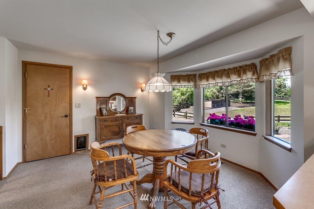 4903 169th Street Southeast Bothell, WA 98012 - Photo 16 of 32 a dining room with furniture a chandelier and window
