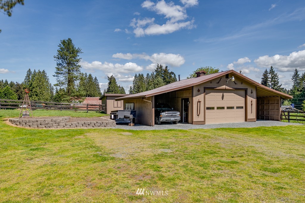 4903 169th Street Southeast Bothell, WA 98012 - Photo 5 of 32 a big house with a big yard and large trees