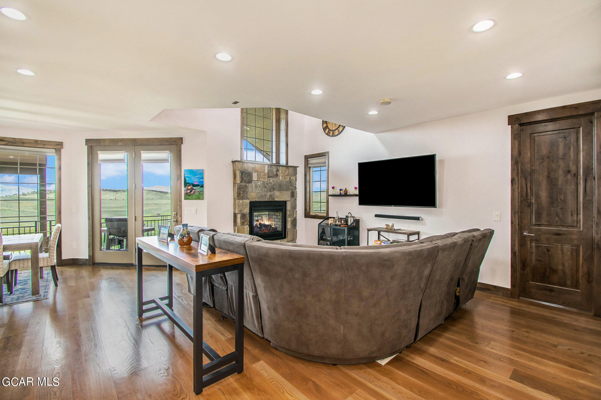 609 Lower Ranch View Drive Granby, CO 80446 - Photo 12 of 54 a living room with furniture a flat screen tv and a fireplace