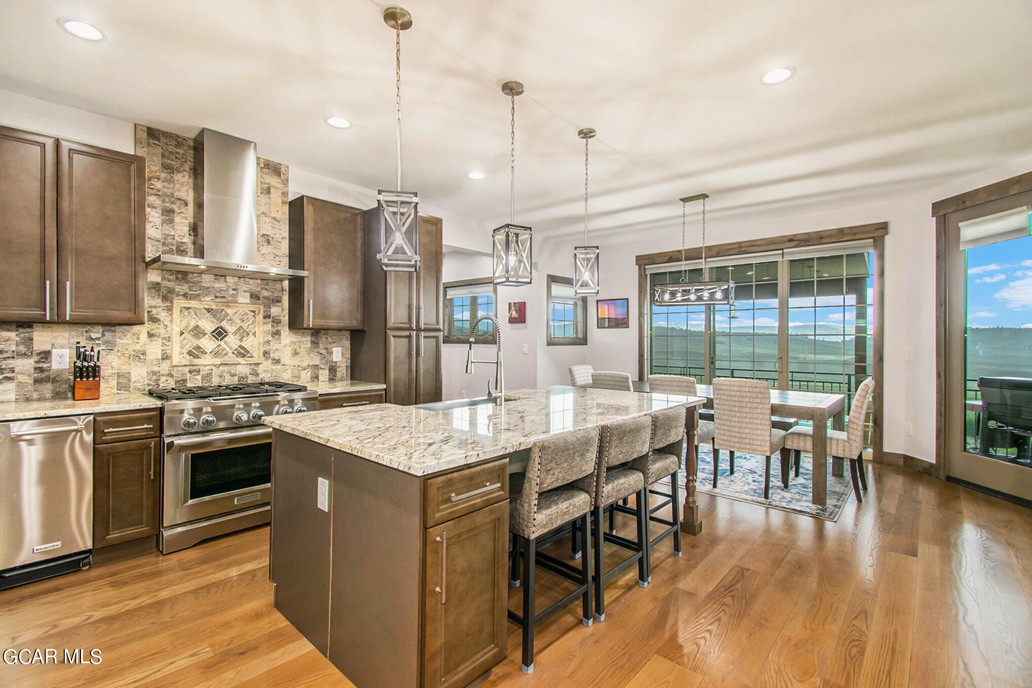 609 Lower Ranch View Drive Granby, CO 80446 - Photo 15 of 54 a kitchen with stainless steel appliances granite countertop a table chairs stove and refrigerator