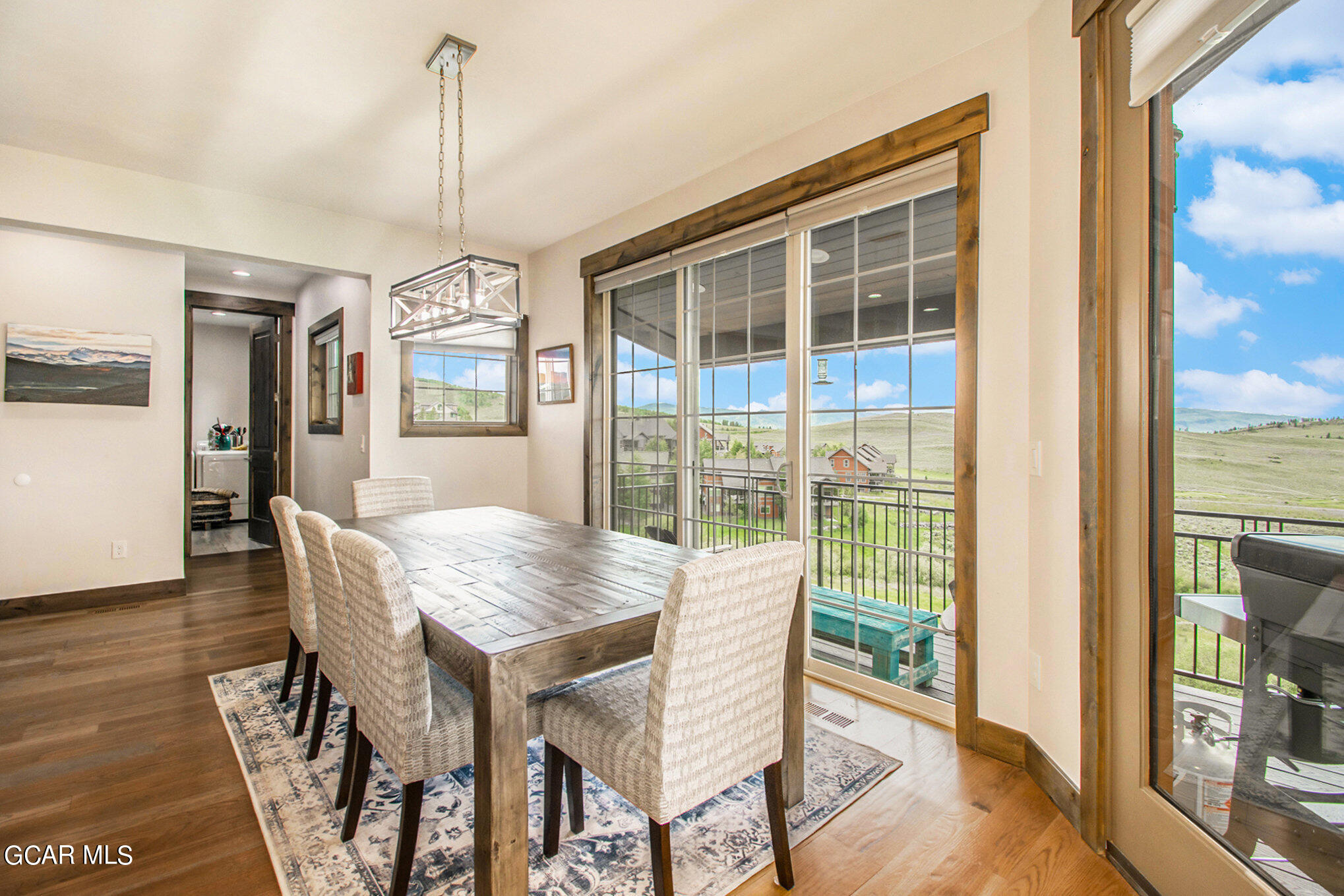 609 Lower Ranch View Drive Granby, CO 80446 - Photo 18 of 54 a view of a dining room with furniture window and wooden floor