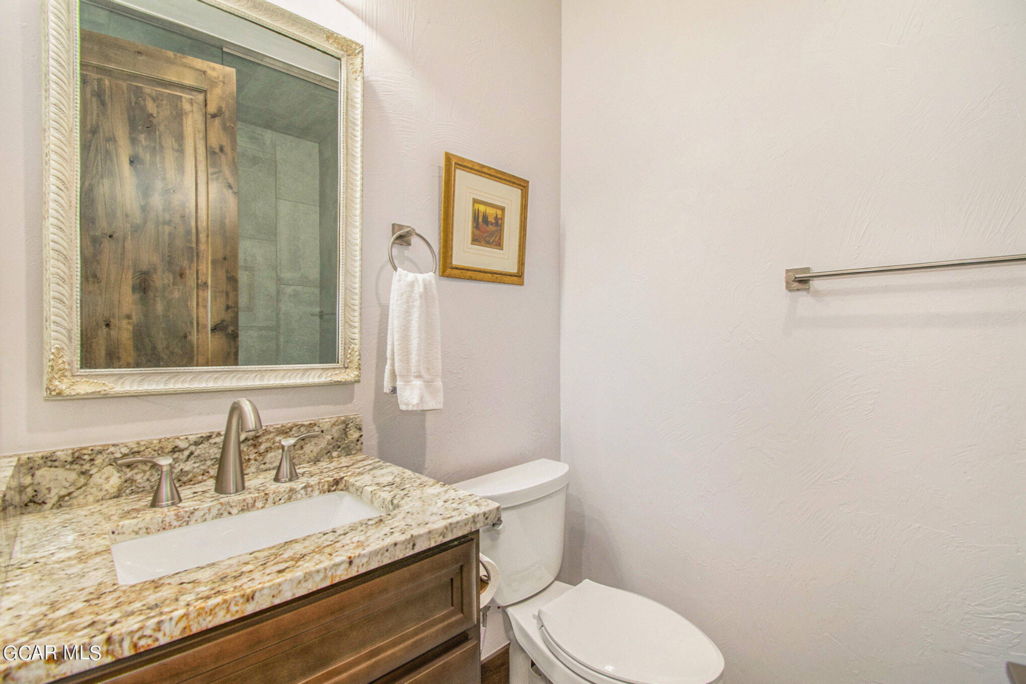 609 Lower Ranch View Drive Granby, CO 80446 - Photo 20 of 54 a bathroom with a granite countertop sink mirror vanity and toilet