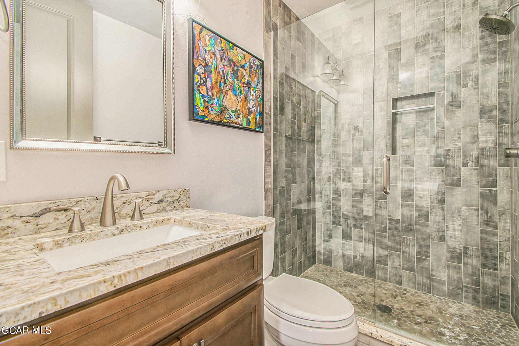 609 Lower Ranch View Drive Granby, CO 80446 - Photo 24 of 54 a bathroom with a granite countertop toilet sink and a shower
