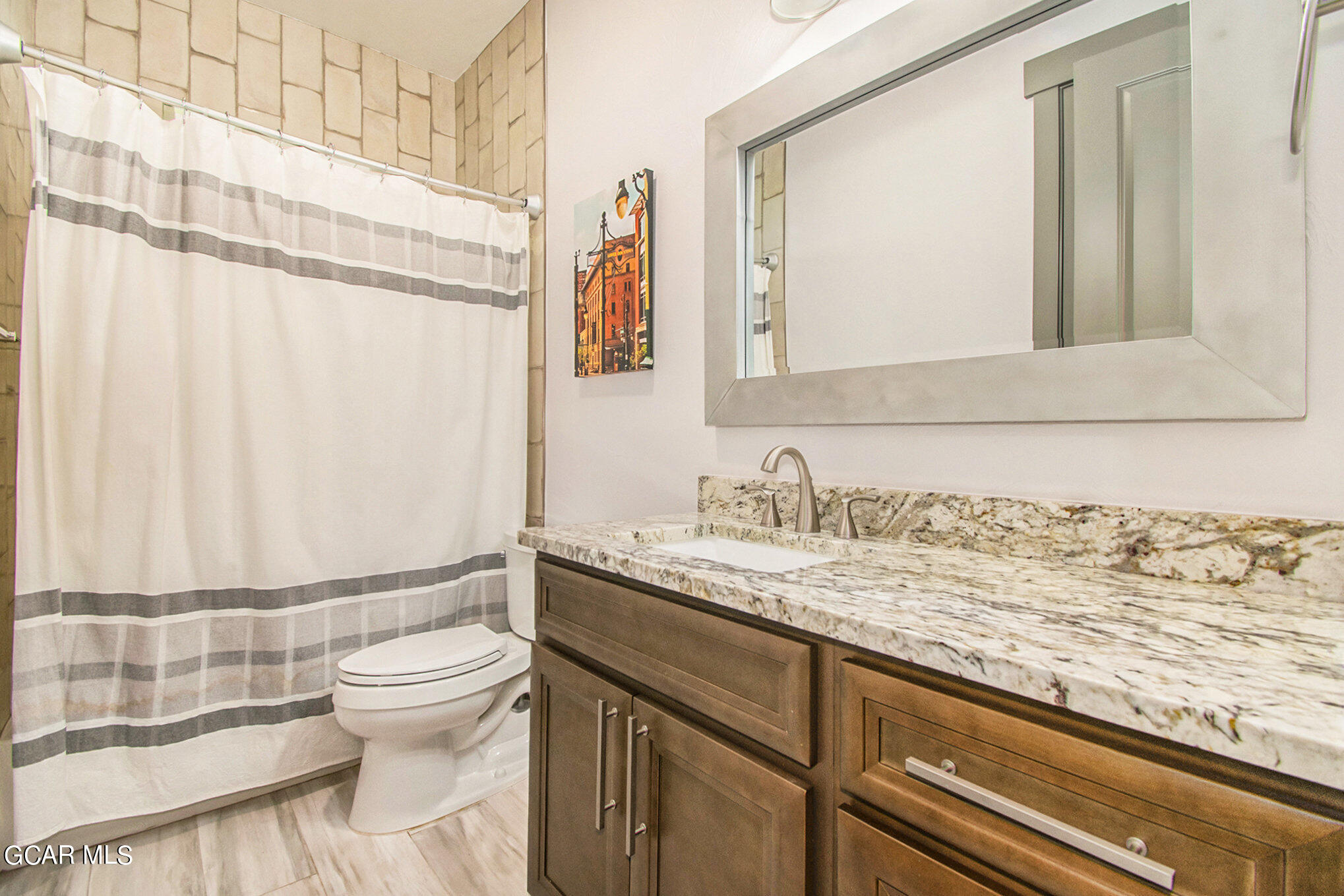 609 Lower Ranch View Drive Granby, CO 80446 - Photo 33 of 54 a bathroom with a granite countertop sink and a toilet