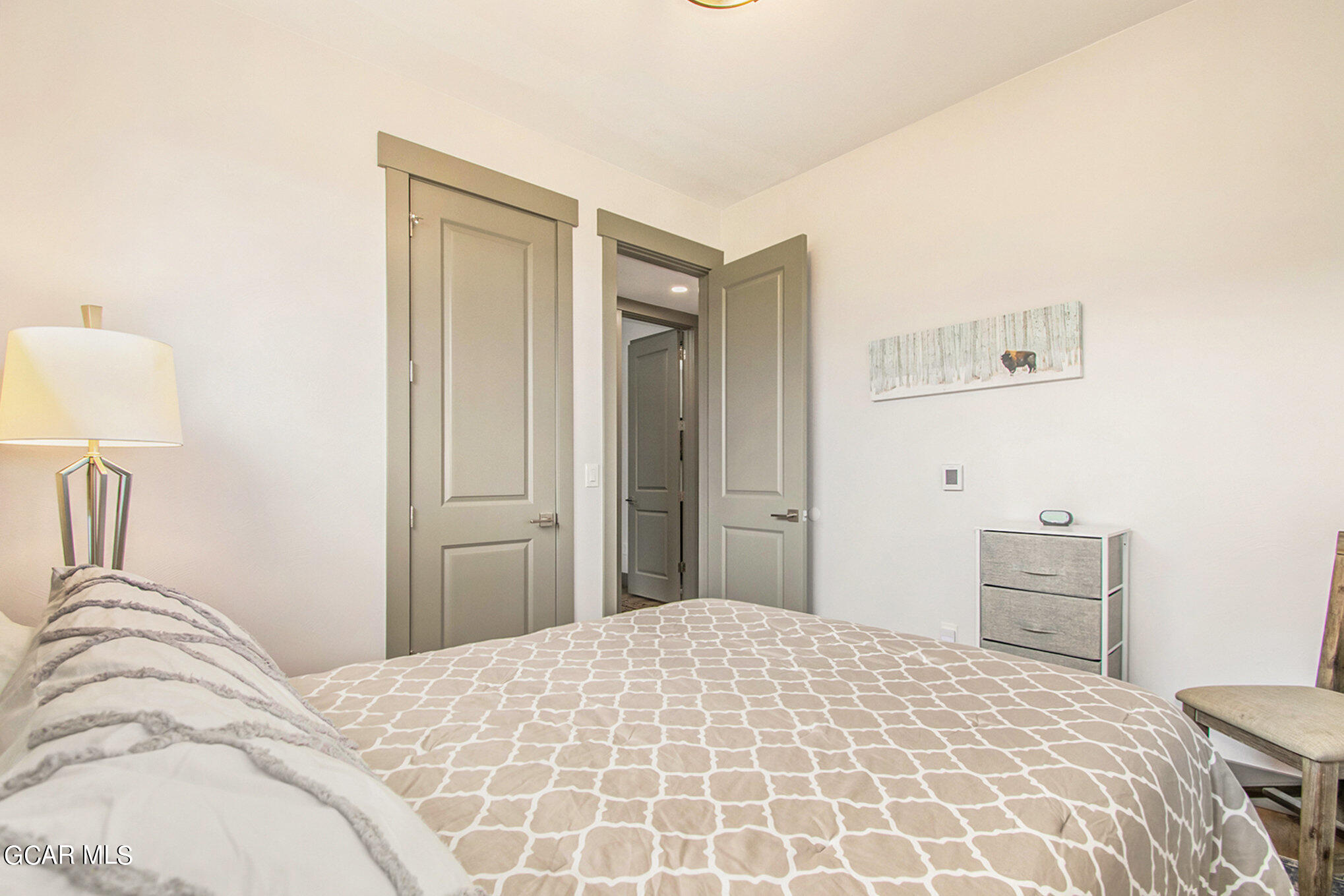 609 Lower Ranch View Drive Granby, CO 80446 - Photo 35 of 54 a bedroom with a bed and a lamp