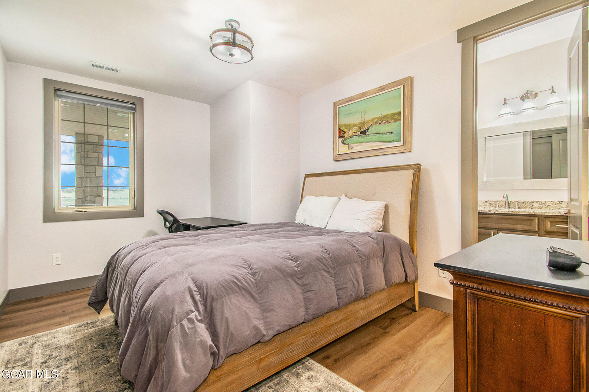 609 Lower Ranch View Drive Granby, CO 80446 - Photo 36 of 54 a bedroom with a bed and two windows