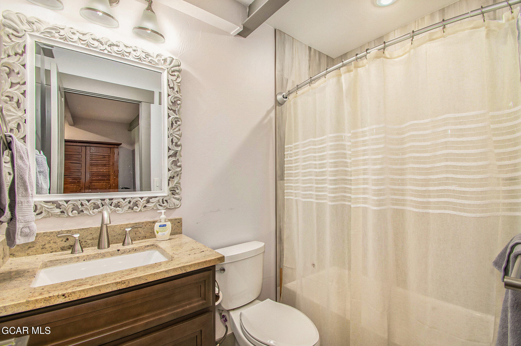 609 Lower Ranch View Drive Granby, CO 80446 - Photo 39 of 54 a bathroom with a granite countertop sink toilet and shower