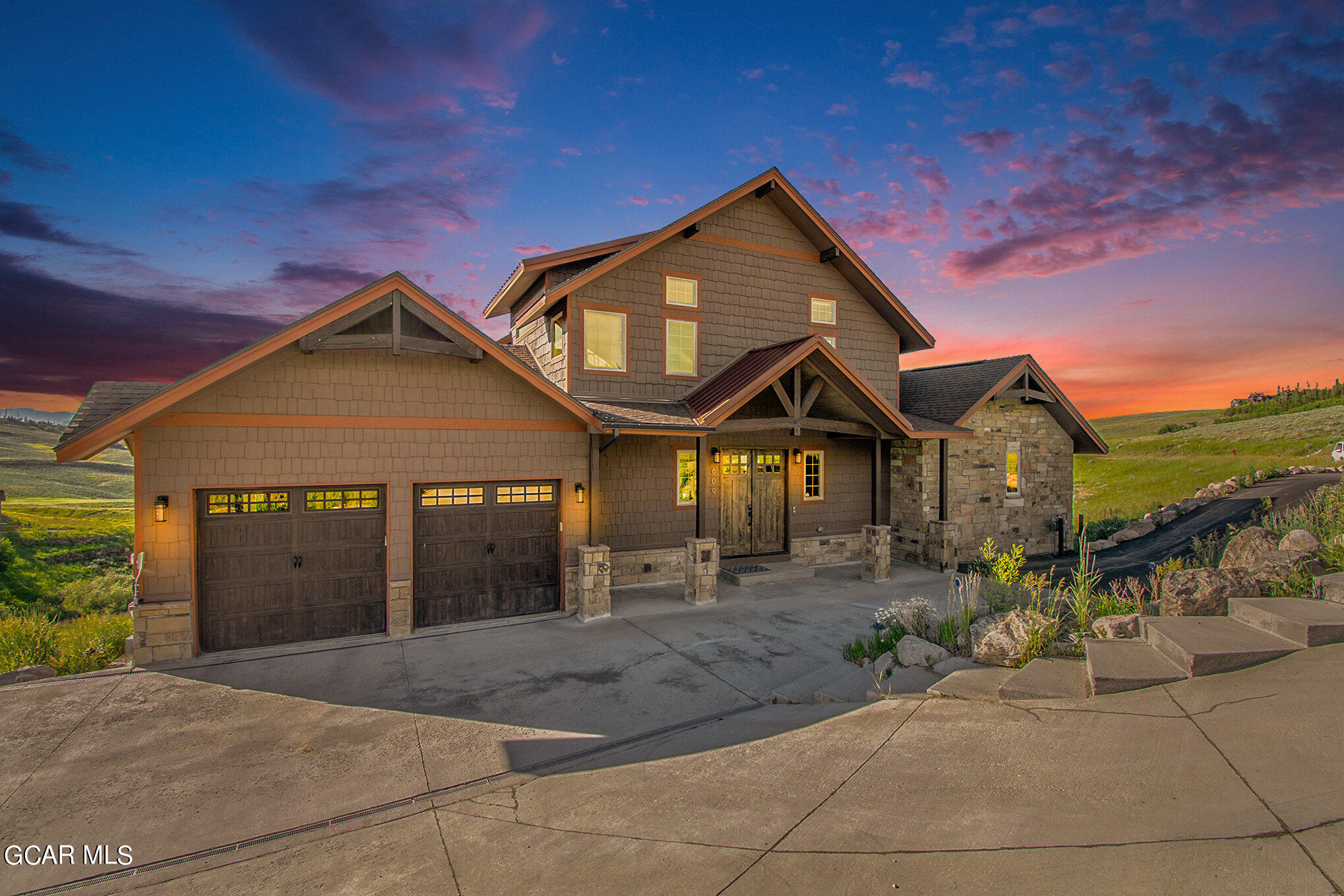 609 Lower Ranch View Drive Granby, CO 80446 - Photo 9 of 54 a front view of a house with a yard and garage