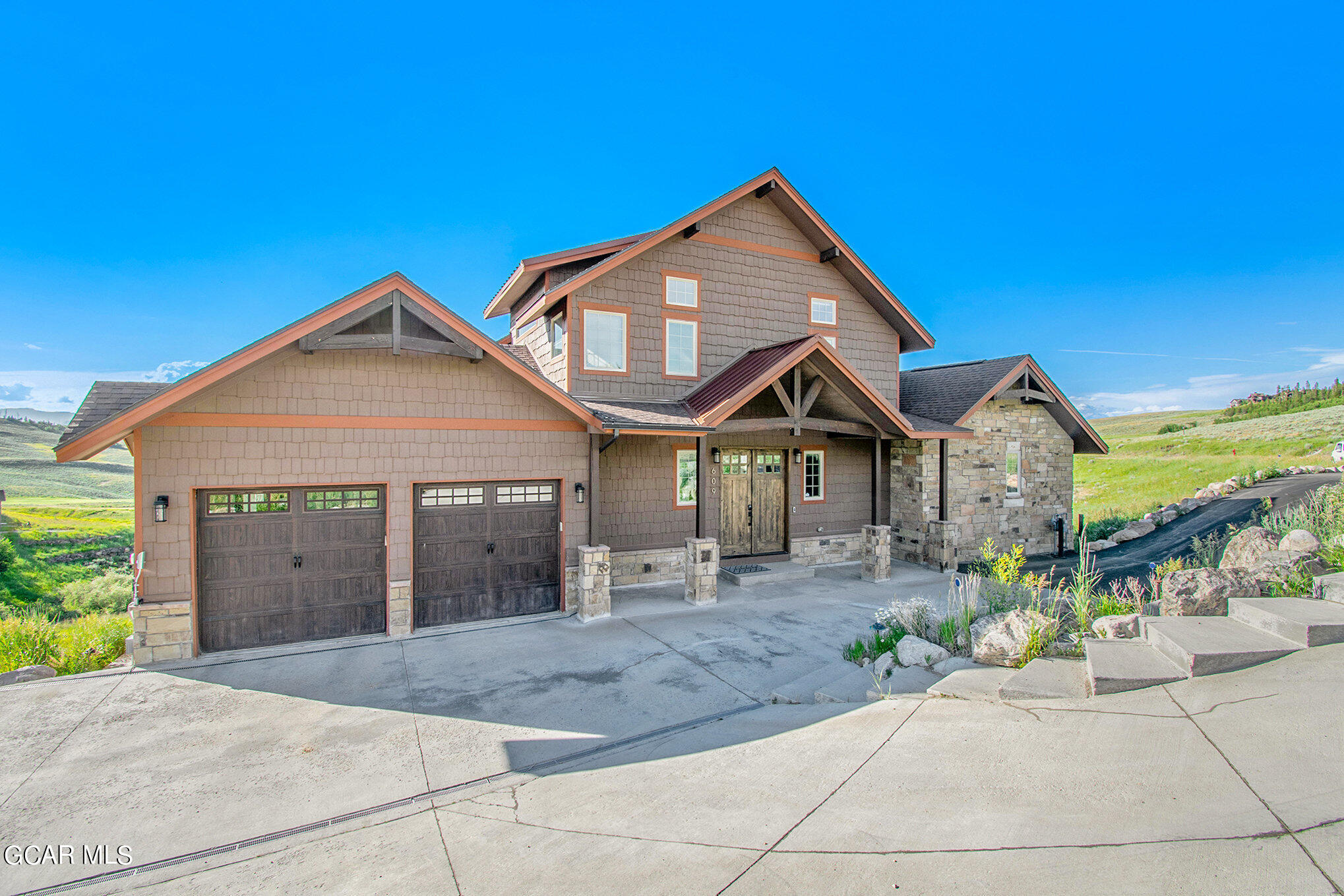 609 Lower Ranch View Drive Granby, CO 80446 - Photo 10 of 54 a front view of a house with a yard and garage
