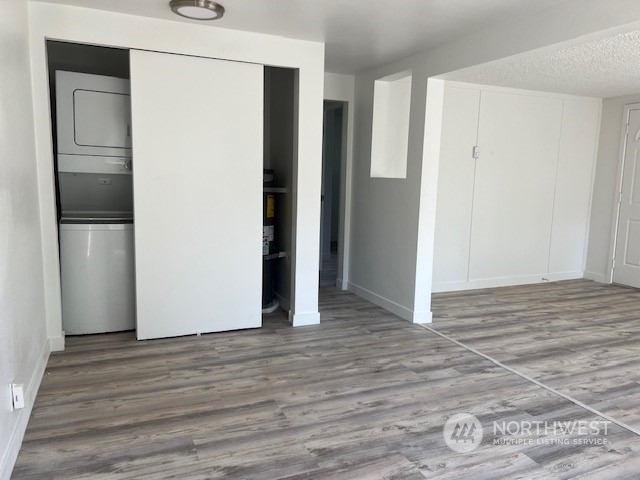 8843 3rd Avenue South Seattle, WA 98108 - Photo 13 of 39 a view of an empty room with wooden floor and a kitchen