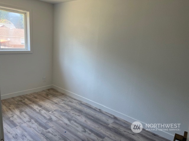 8843 3rd Avenue South Seattle, WA 98108 - Photo 17 of 39 an empty room with wooden floor and windows
