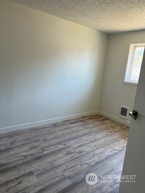 8843 3rd Avenue South Seattle, WA 98108 - Photo 18 of 39 a view of empty room with wooden floor