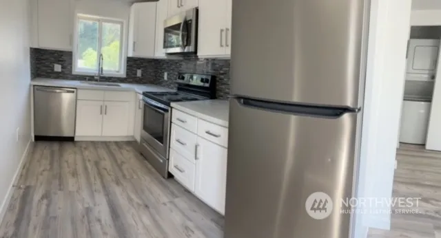 a kitchen with a refrigerator a sink and cabinets