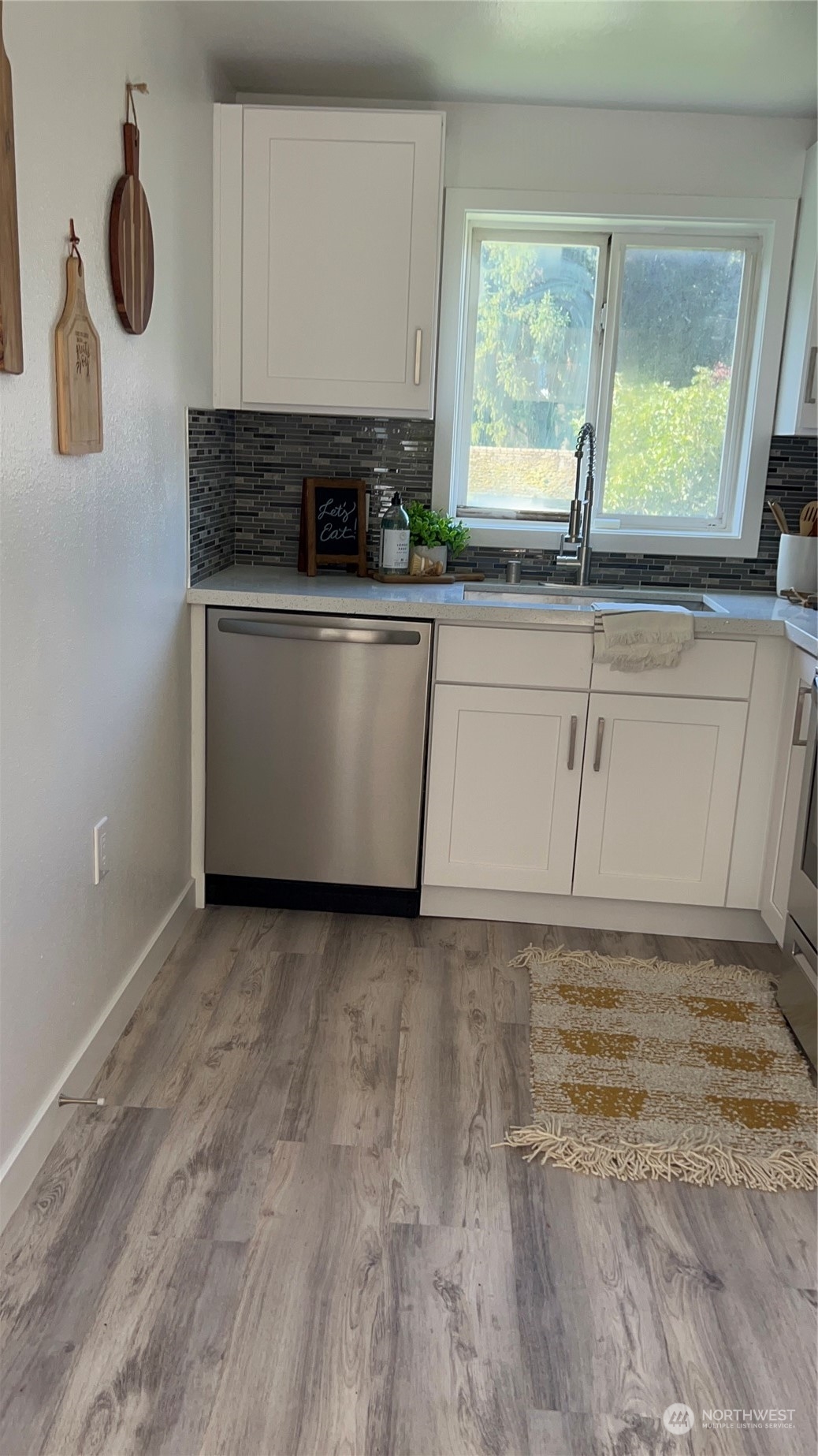 8843 3rd Avenue South Seattle, WA 98108 - Photo 22 of 39 a view of a kitchen with a sink and wooden floor