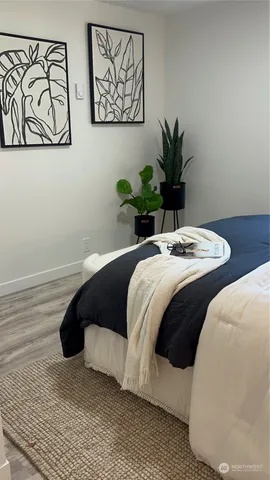 a bedroom with a bed lamp and a potted plant