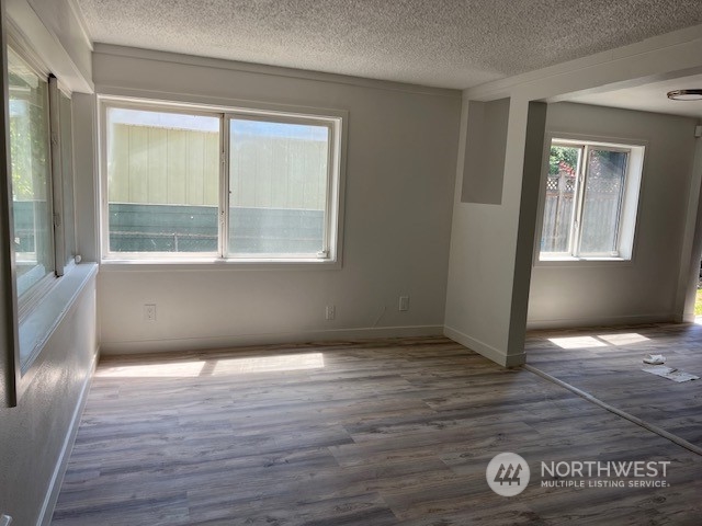 8843 3rd Avenue South Seattle, WA 98108 - Photo 4 of 39 an empty room with wooden floor and windows
