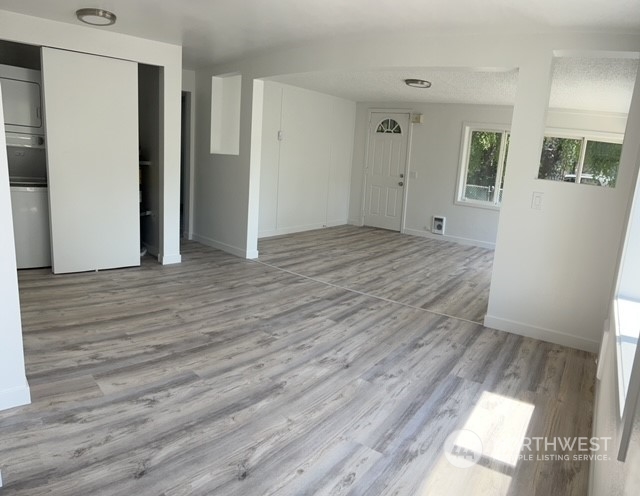 8843 3rd Avenue South Seattle, WA 98108 - Photo 5 of 39 a view of an empty room with wooden floor and a window