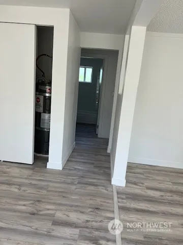 a view of a hallway with wooden floor and staircase