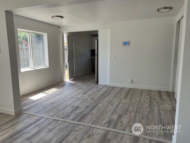 8843 3rd Avenue South Seattle, WA 98108 - Photo 9 of 39 an empty room with wooden floor and windows