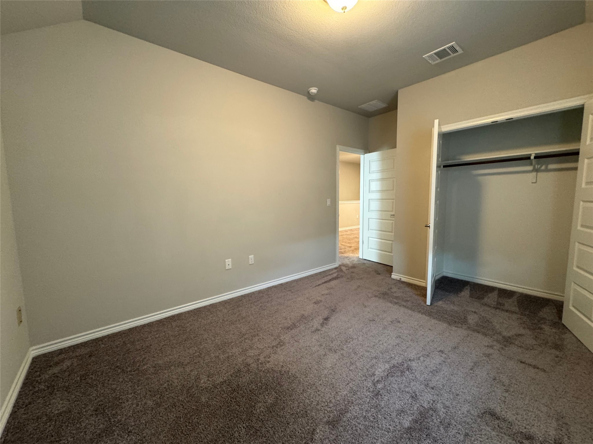 14100 McCoy Loop, Unit 1 Austin, TX 78717 - Photo 27 of 39 A well-proportioned bedroom offers comfortable carpeting and convenient closet space.